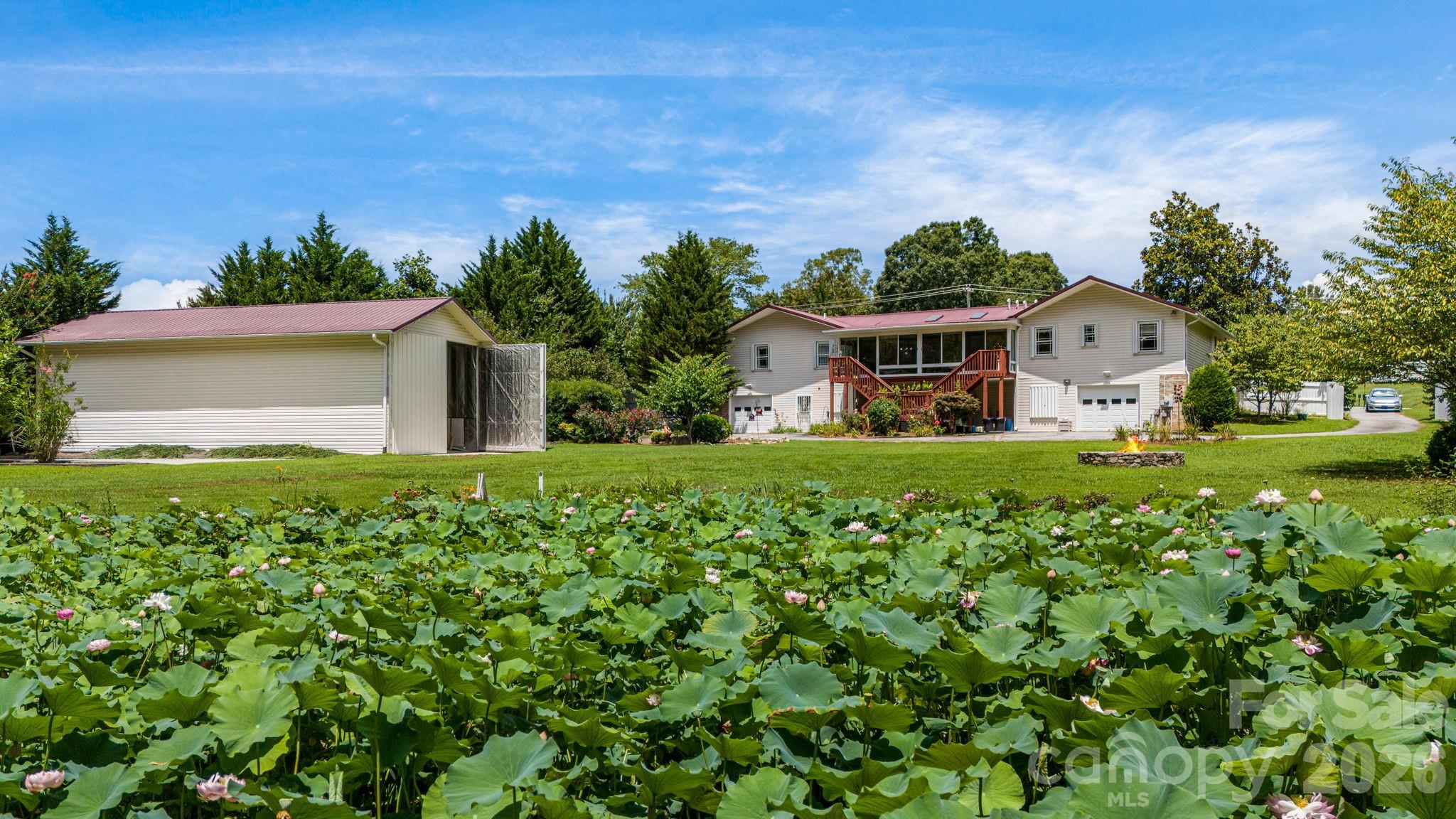 350 Old Sunset Hill Road Hendersonville, NC 28792 - Photo 32 of 40 a front view of a house with a garden