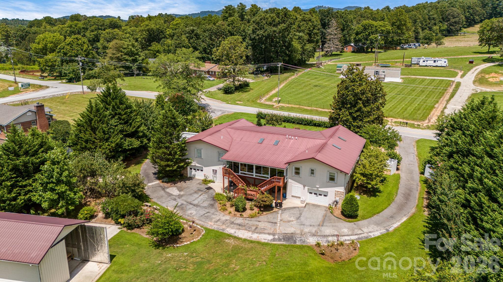 350 Old Sunset Hill Road Hendersonville, NC 28792 - Photo 36 of 40 an aerial view of a house with a garden and swimming pool