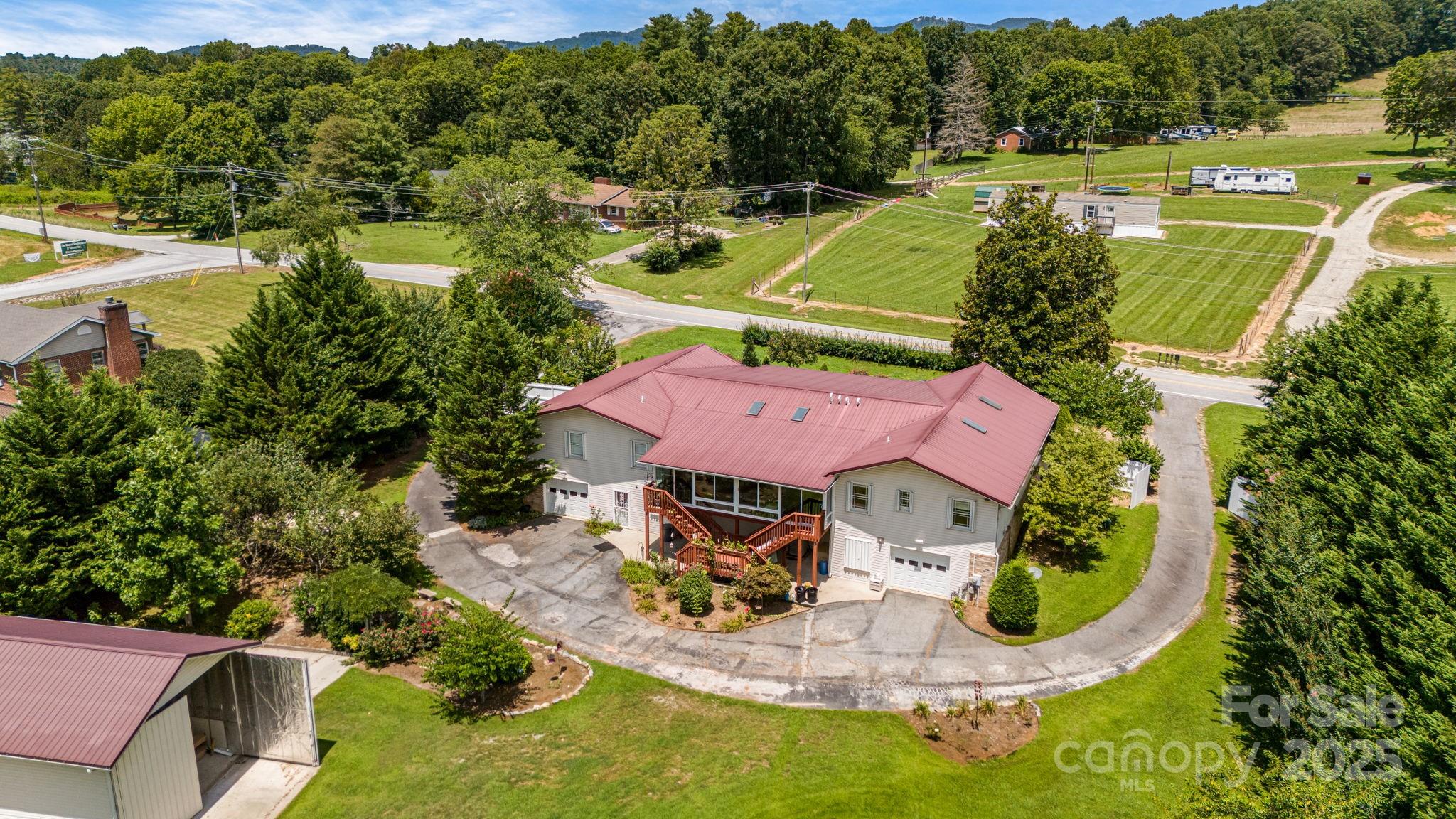 350 Old Sunset Hill Road Hendersonville, NC 28792 - Photo 38 of 40 an aerial view of a house with a garden and swimming pool