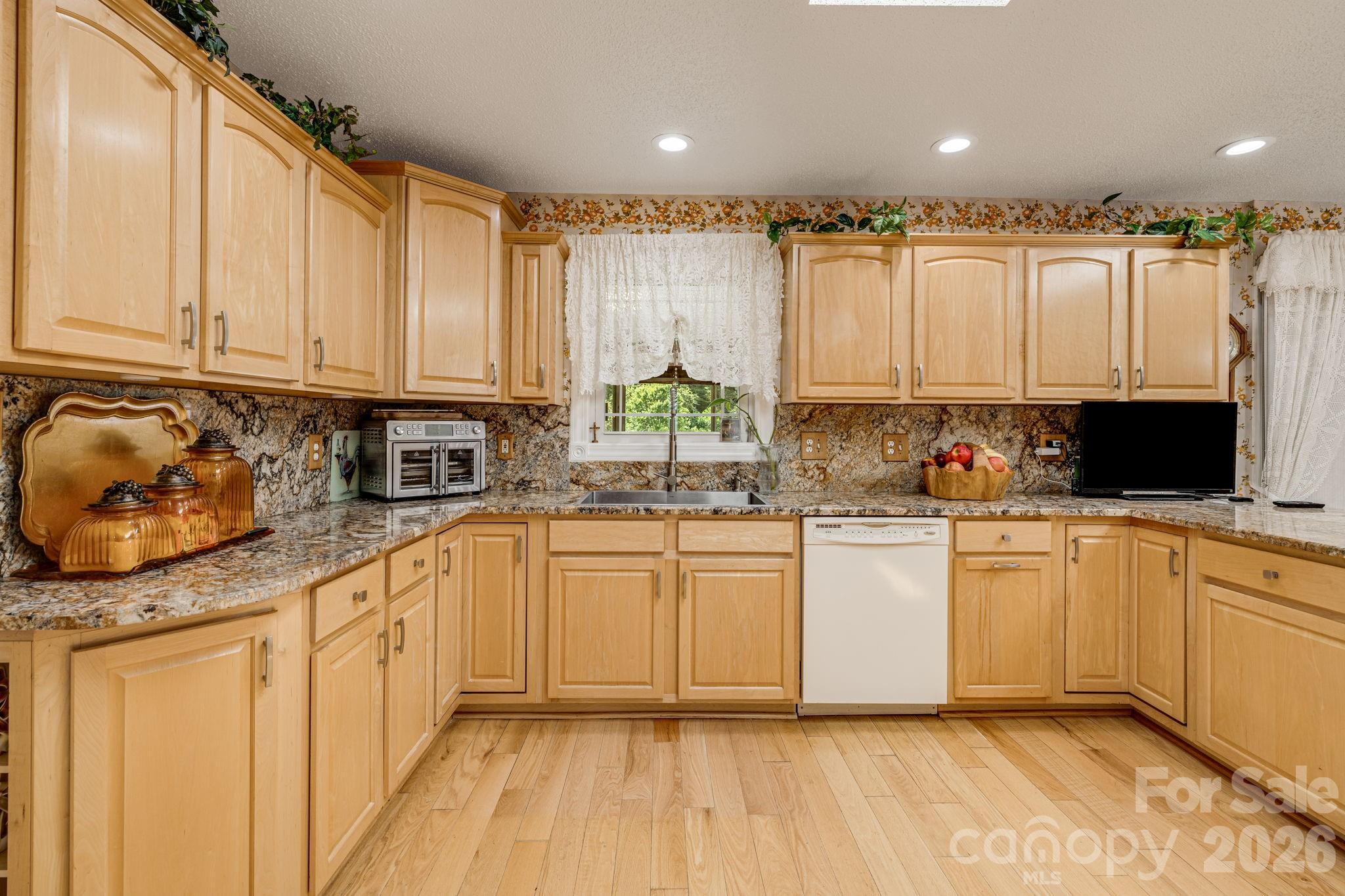 350 Old Sunset Hill Road Hendersonville, NC 28792 - Photo 40 of 40 a kitchen with stainless steel appliances granite countertop a stove a sink and white cabinets