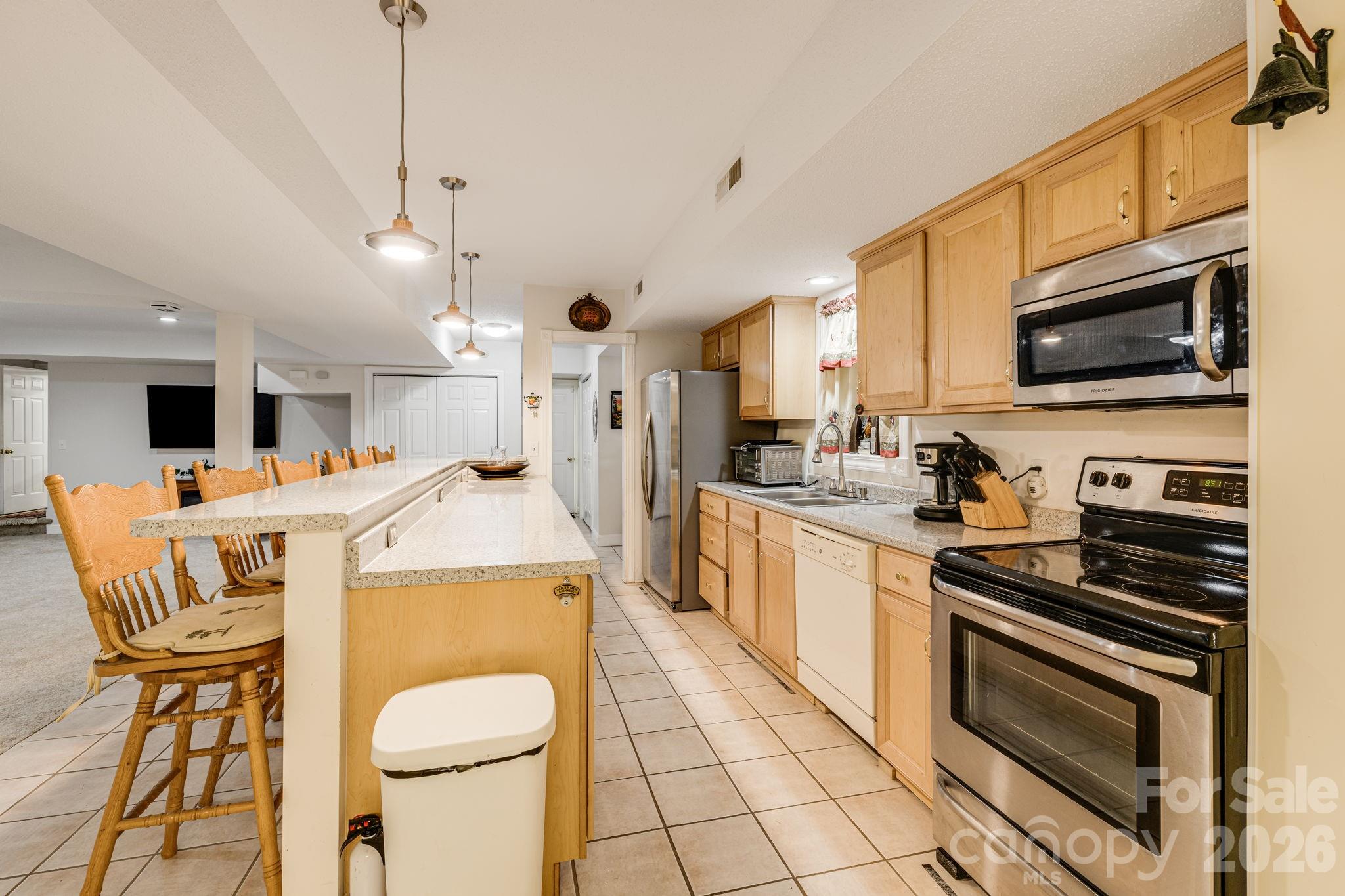 350 Old Sunset Hill Road Hendersonville, NC 28792 - Photo 5 of 40 a kitchen that has a stove a microwave and a dining table