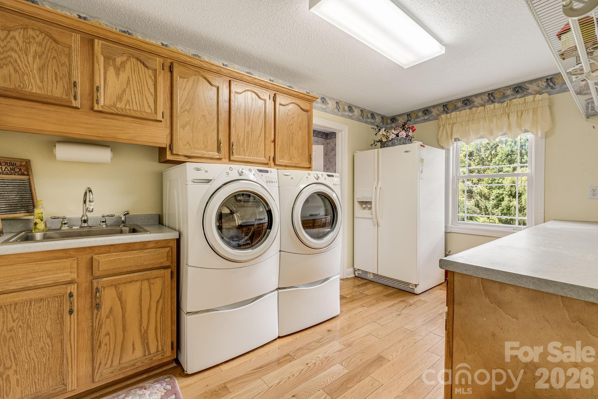 350 Old Sunset Hill Road Hendersonville, NC 28792 - Photo 7 of 40 a utility room with sink dryer and washer