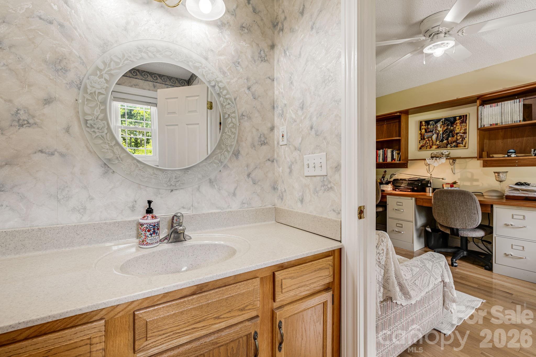 350 Old Sunset Hill Road Hendersonville, NC 28792 - Photo 8 of 40 a en suite bathroom with a sink and a mirror