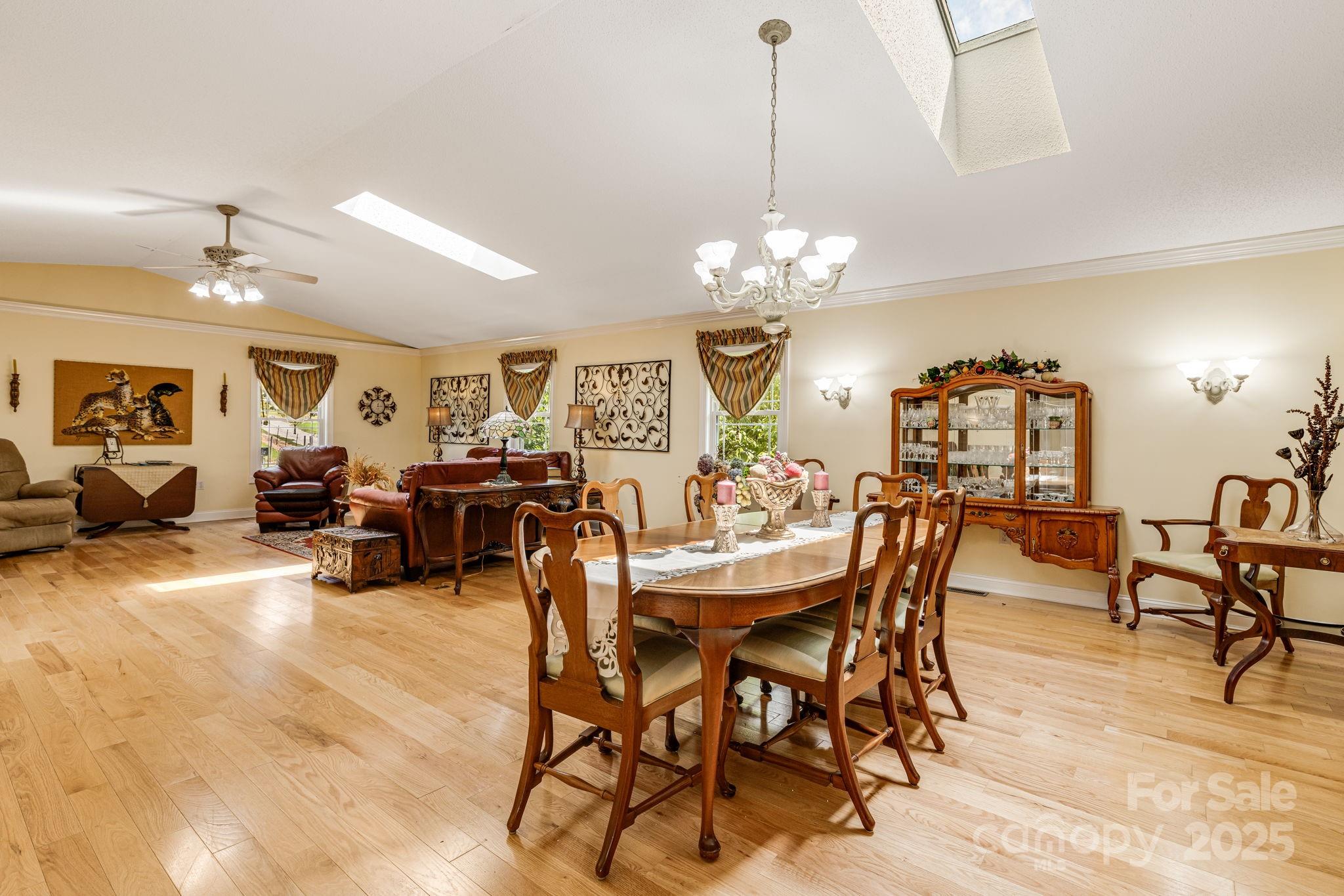 350 Old Sunset Hill Road Hendersonville, NC 28792 - Photo 8 of 40 a view of a dining room and livingroom with furniture a chandelier and wooden floor