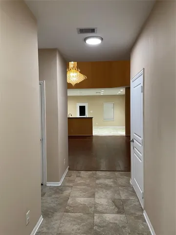 a view of a hallway to room and window