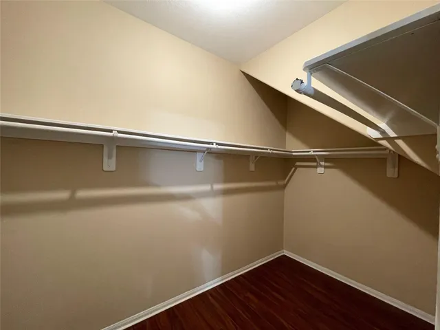 a view of a room with wooden floor