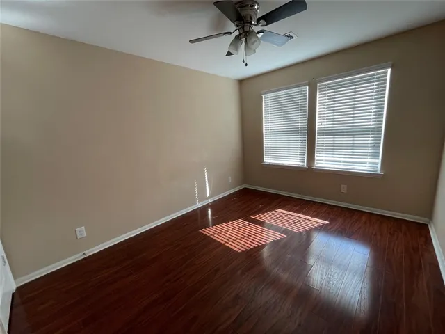 a view of wooden floor and windows in a room