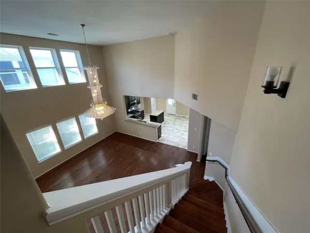 a view of a hallway with furniture and a window