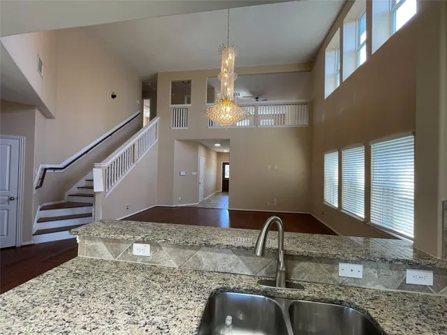 a kitchen with a sink and chandelier