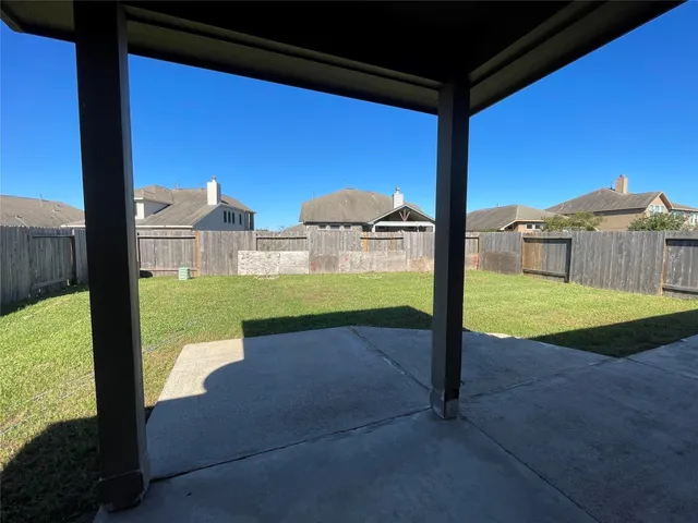 a view of a balcony with yard
