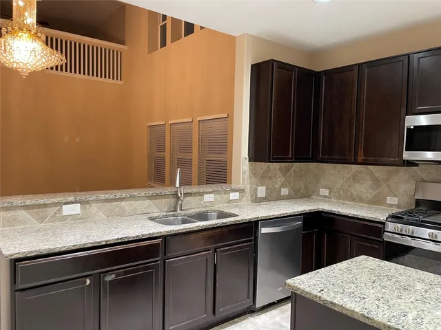 a kitchen with a sink and cabinets