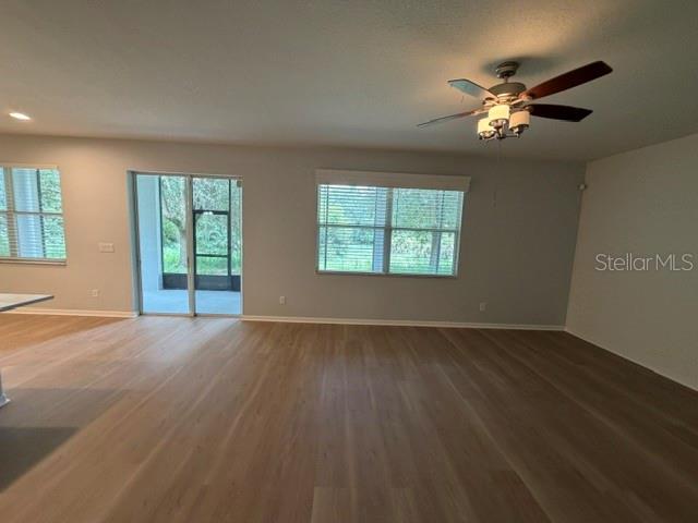 1885 Scrub Jay Road Apopka, FL 32703 - Photo 11 of 29 a view of an empty room with wooden floor and a window