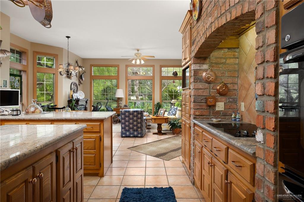 27603 Palo Verde Road San Benito, TX 78586 - Photo 18 of 45 a kitchen with stainless steel appliances kitchen island granite countertop a sink and cabinets