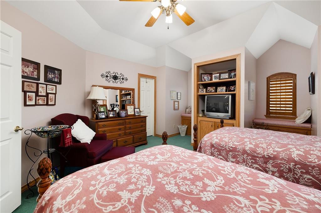 27603 Palo Verde Road San Benito, TX 78586 - Photo 26 of 45 a bedroom with a bed and a chandelier