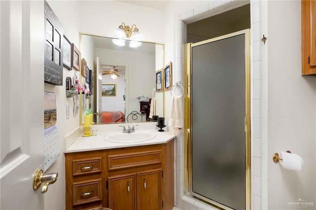 27603 Palo Verde Road San Benito, TX 78586 - Photo 29 of 45 a bathroom with a granite countertop sink and a mirror