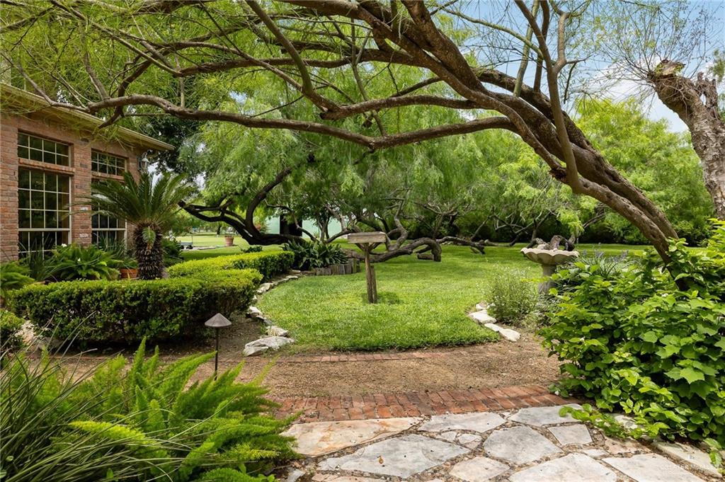 27603 Palo Verde Road San Benito, TX 78586 - Photo 33 of 45 a backyard of a house with a yard and outdoor seating