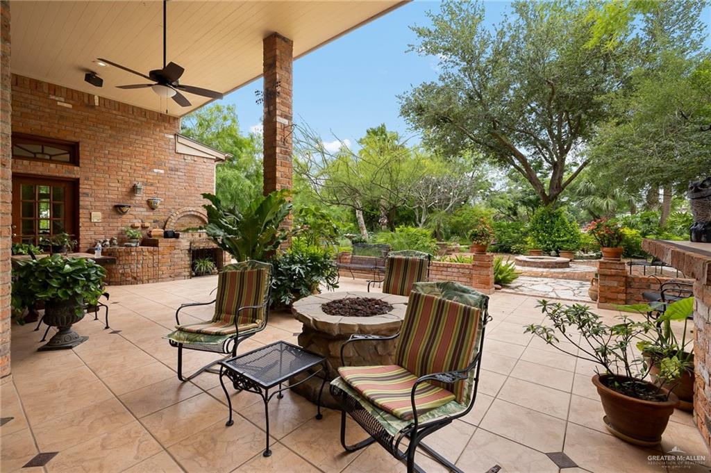 27603 Palo Verde Road San Benito, TX 78586 - Photo 35 of 45 a view of a chairs and table in backyard
