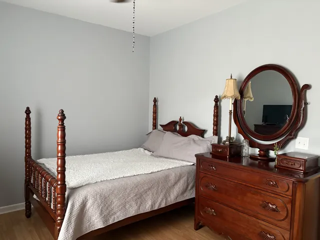 a bedroom with a bed and a table