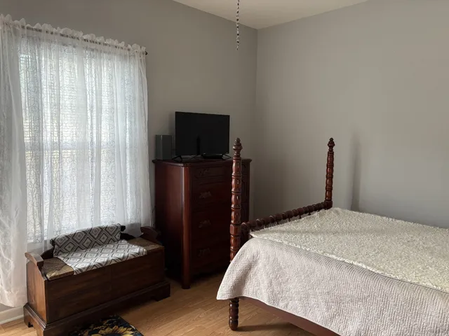 a bedroom with a bed and a television