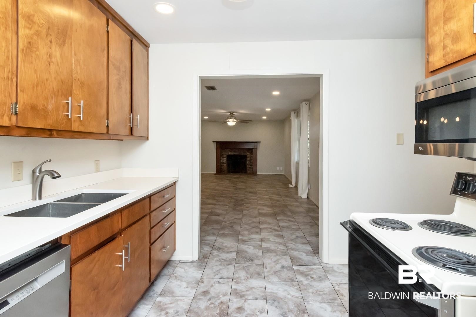 5412 South Norden Drive Mobile, AL 36608 - Photo 18 of 38 Kitchen featuring a fireplace, stainless steel appliances, ceiling fan, and sink