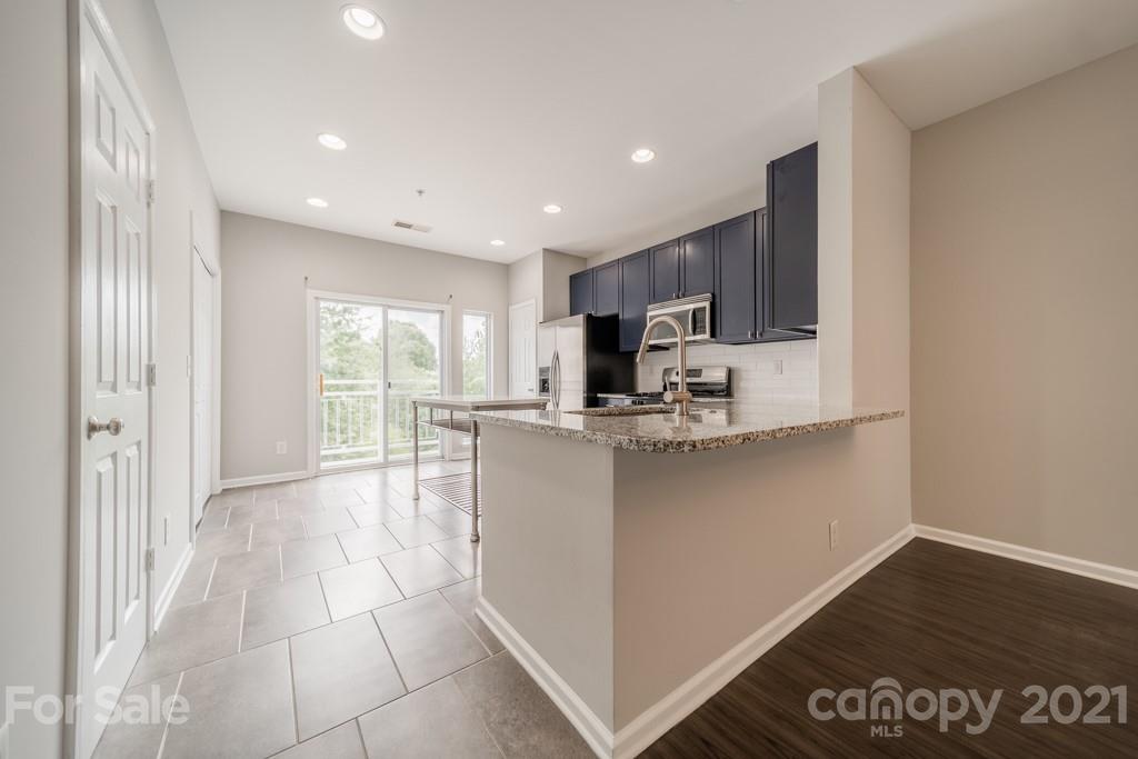 632 Raphael Place Charlotte, NC 28205 - Photo 12 of 37 a kitchen with stainless steel appliances granite countertop a refrigerator and a stove top oven