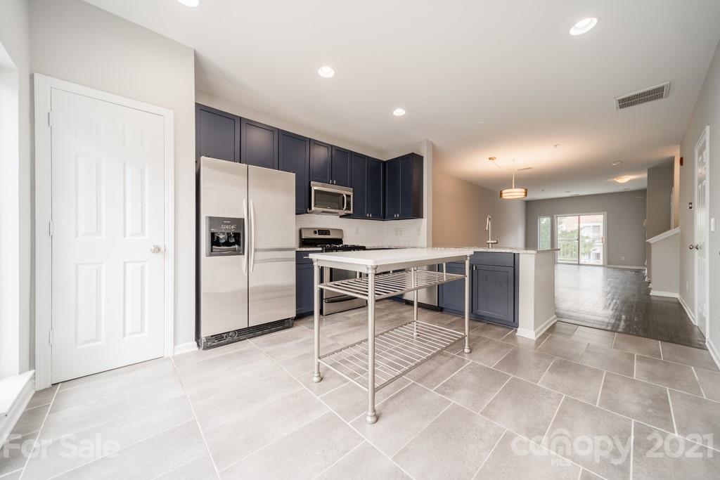 632 Raphael Place Charlotte, NC 28205 - Photo 13 of 37 a kitchen with stainless steel appliances a refrigerator and a sink