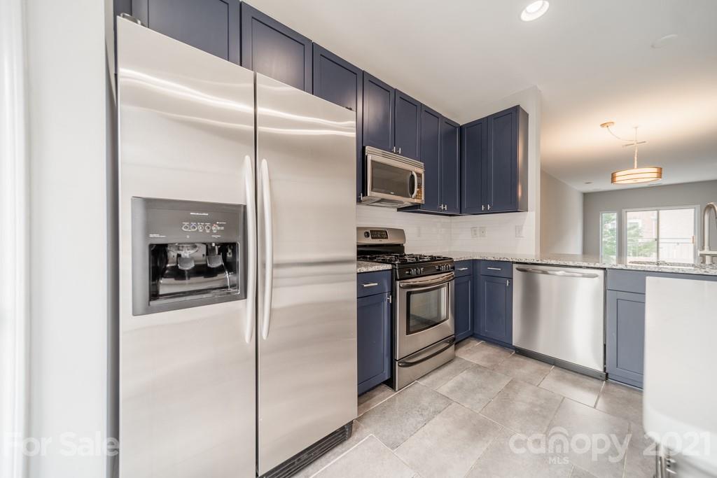 632 Raphael Place Charlotte, NC 28205 - Photo 16 of 37 a kitchen with a refrigerator and a sink