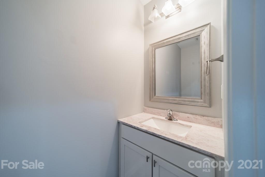 632 Raphael Place Charlotte, NC 28205 - Photo 19 of 37 a bathroom with a granite countertop sink and a mirror