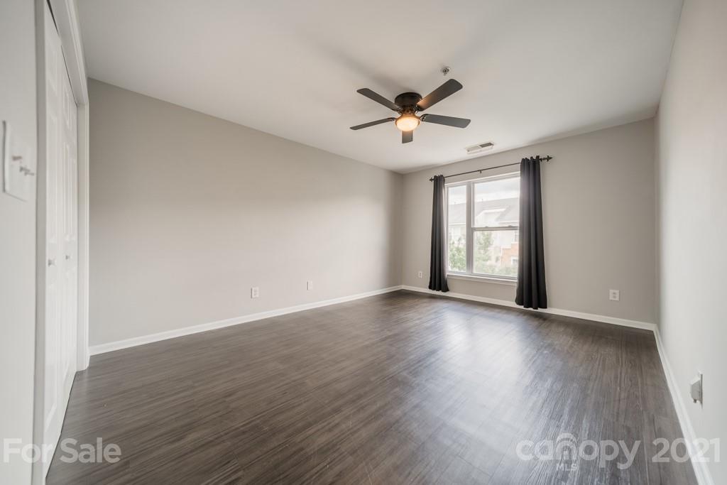 632 Raphael Place Charlotte, NC 28205 - Photo 26 of 37 a view of an empty room with a window and wooden floor