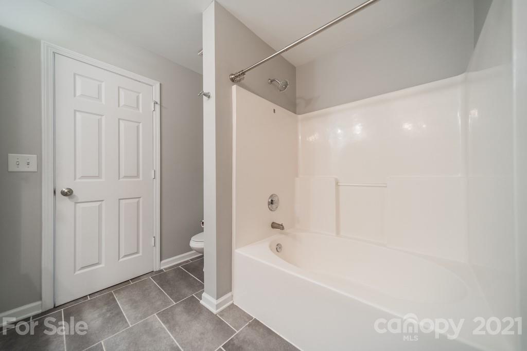 632 Raphael Place Charlotte, NC 28205 - Photo 29 of 37 a bathroom with a bathtub and a shower