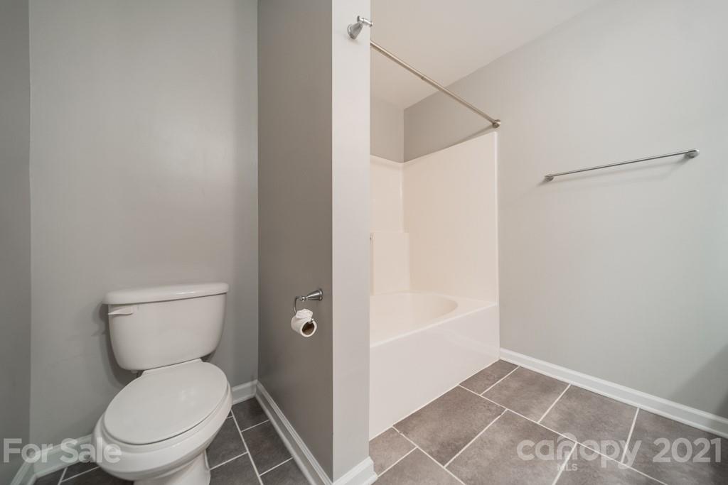 632 Raphael Place Charlotte, NC 28205 - Photo 30 of 37 a bathroom with a toilet and a shower