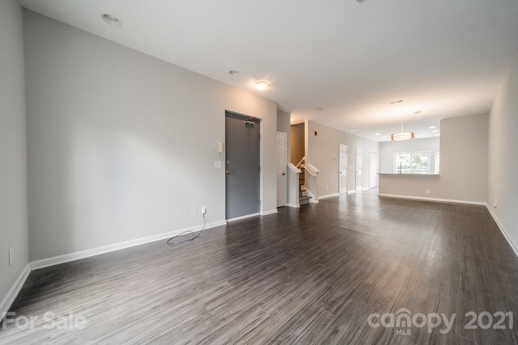 632 Raphael Place Charlotte, NC 28205 - Photo 7 of 37 a view of an empty room with a window and wooden floor