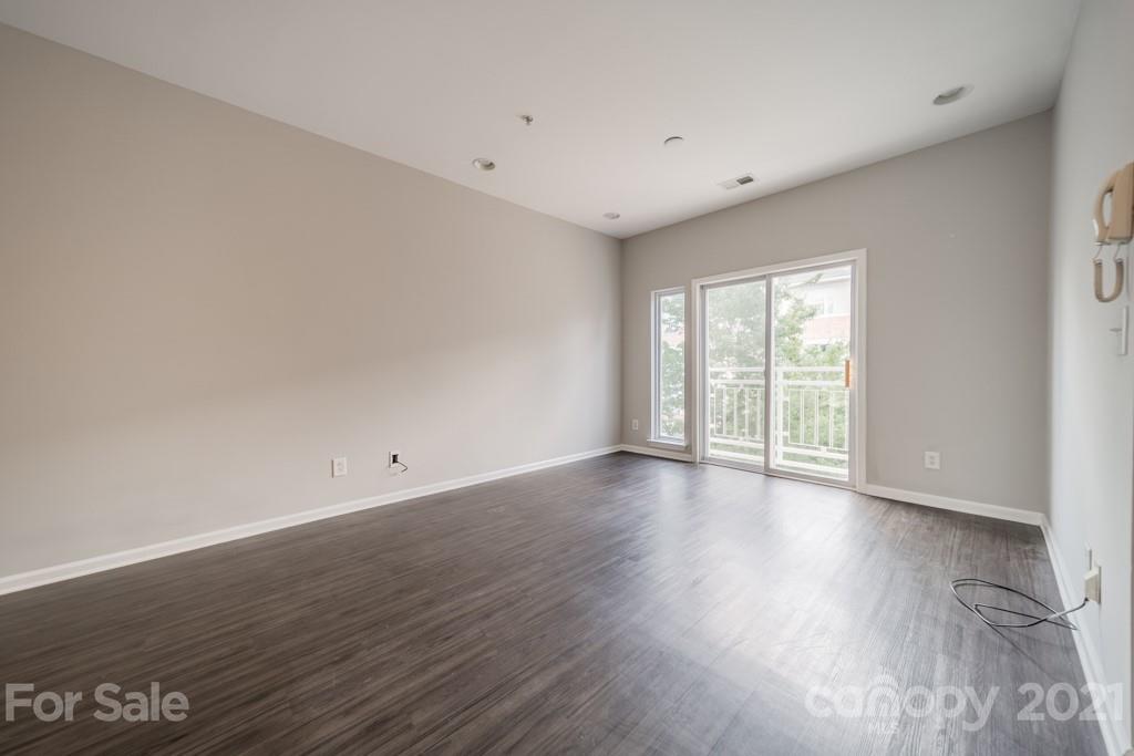 632 Raphael Place Charlotte, NC 28205 - Photo 8 of 37 a view of an empty room with wooden floor and a window