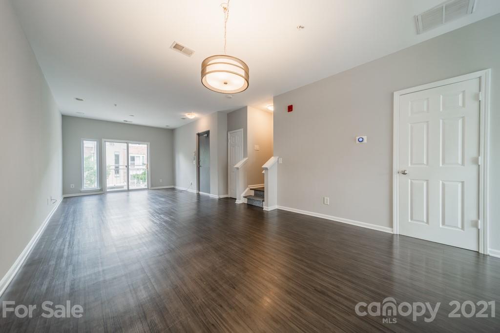 632 Raphael Place Charlotte, NC 28205 - Photo 9 of 37 a view of an empty room with wooden floor and window