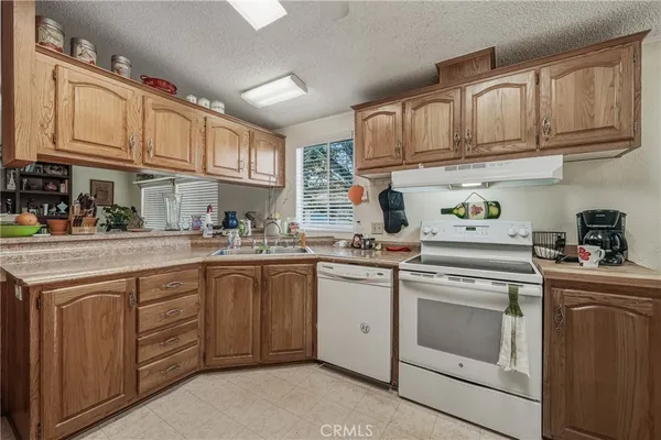 a kitchen with cabinets appliances a sink and a counter top space
