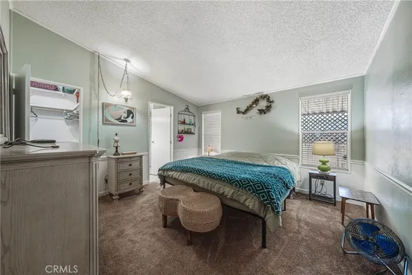 a bedroom with a bed and a table