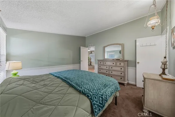 a bedroom with a bed and a television