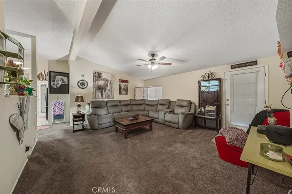 a living room with furniture gym equipment and a window