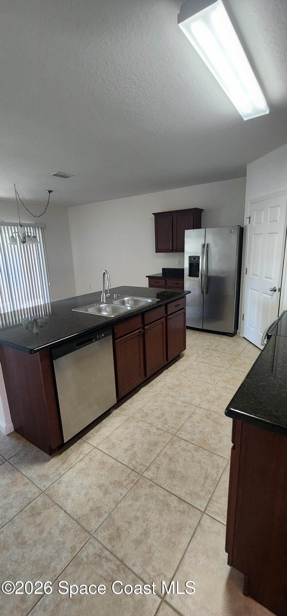 1957 Elkins Point Melbourne, FL 32935 - Photo 12 of 27 a kitchen with a sink a counter top space cabinets and stainless steel appliances