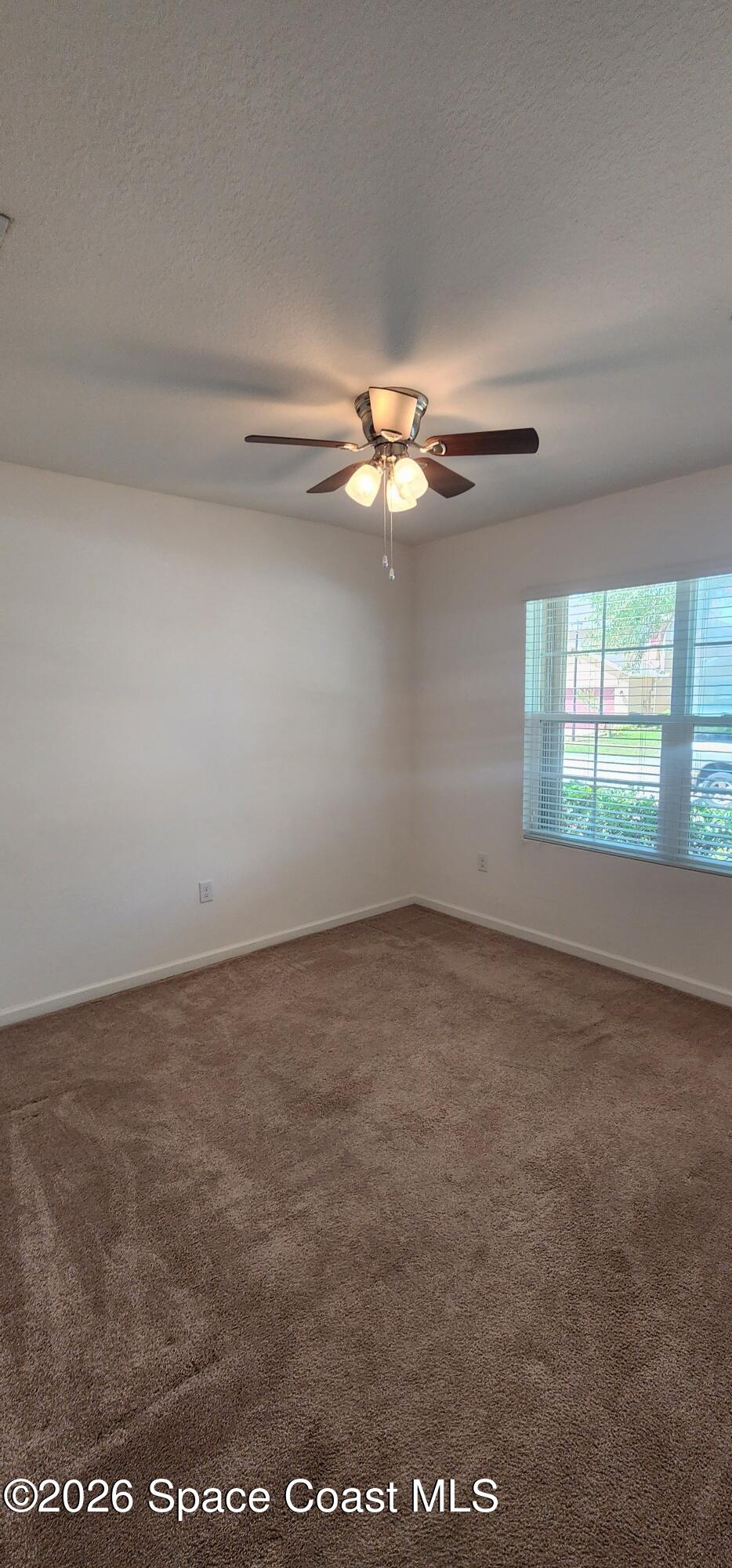 1957 Elkins Point Melbourne, FL 32935 - Photo 3 of 27 wooden floor in an empty room with a window