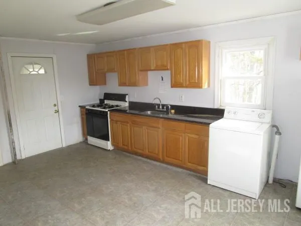 a kitchen with a sink stove and cabinets