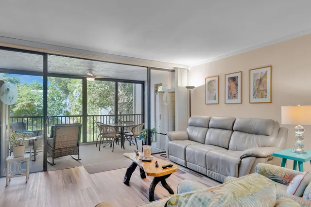 a balcony view with a large window and dining table