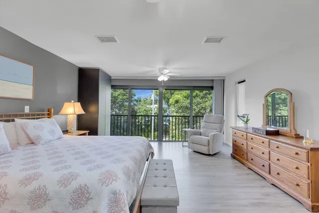 a bedroom with bed and a chandelier