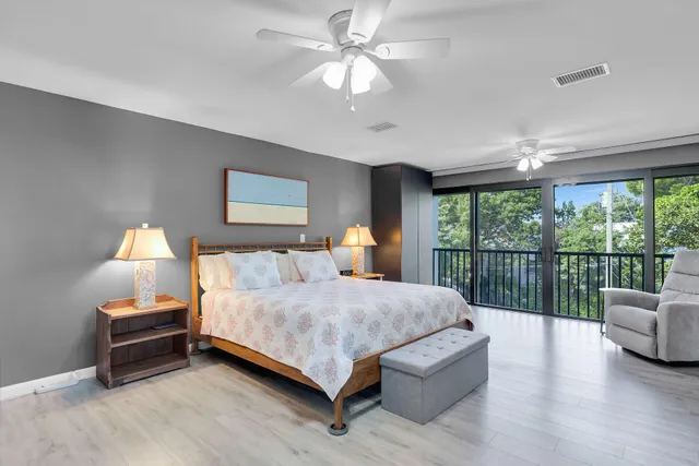 a bedroom with a bed dresser and a flat tv screen