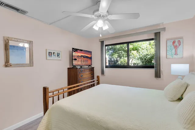 a front view of a house with a yard and a garden