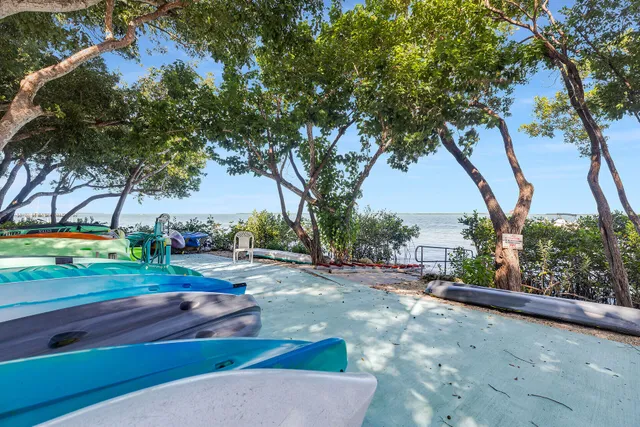a view of a swimming pool with sitting area and furniture