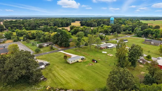 a view of a lake with lawn chairs