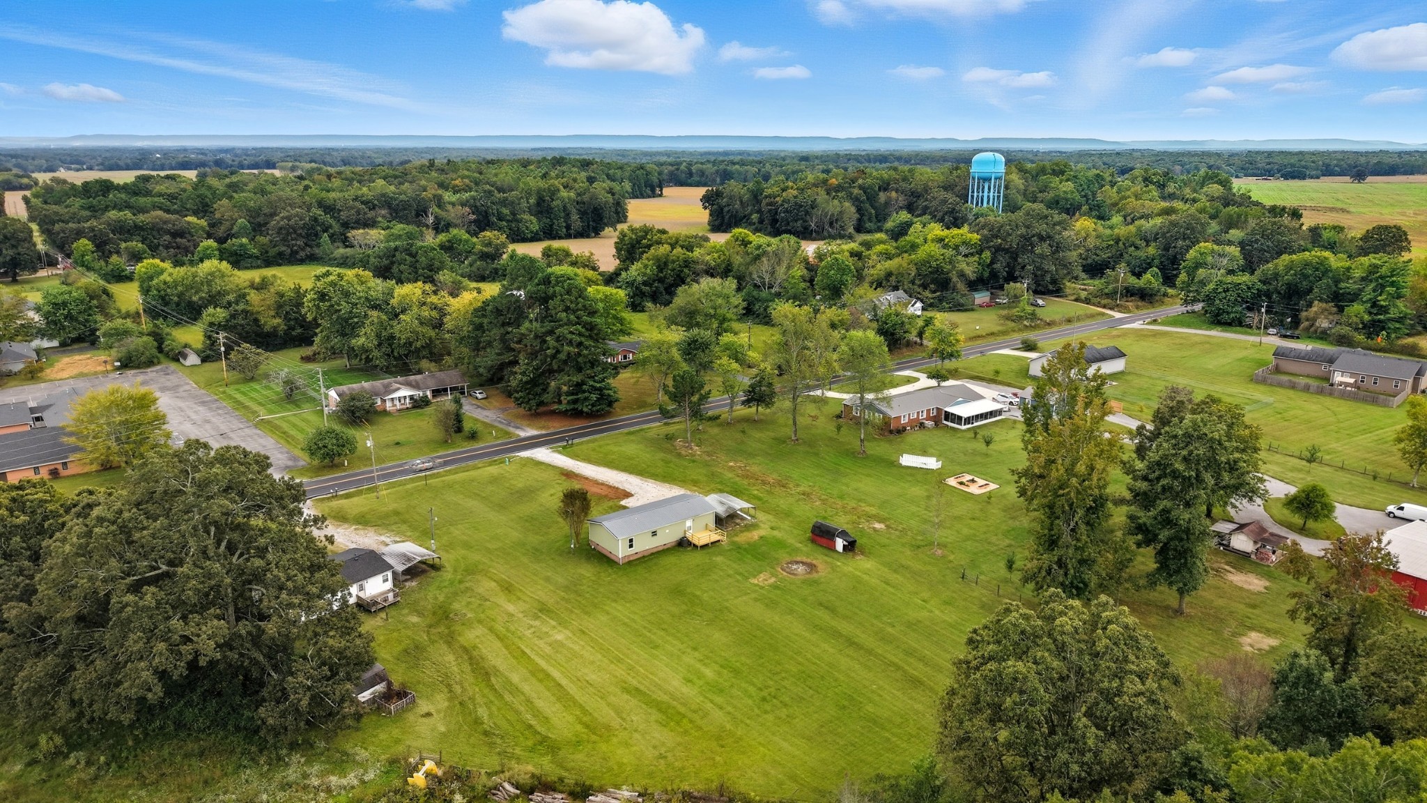 a view of a lake with lawn chairs