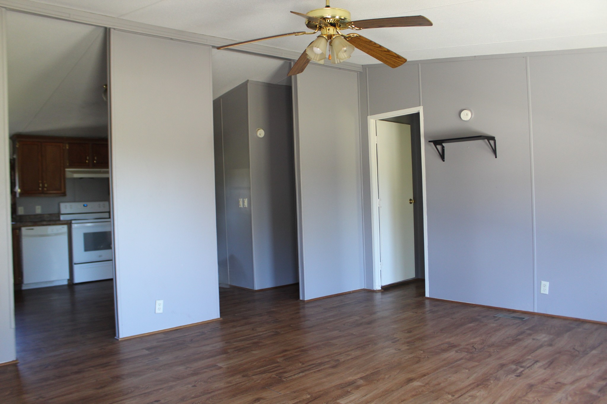 5453 Awalt Road Tullahoma, TN 37388 - Photo 7 of 19 a view of an empty room with wooden floor and a ceiling fan