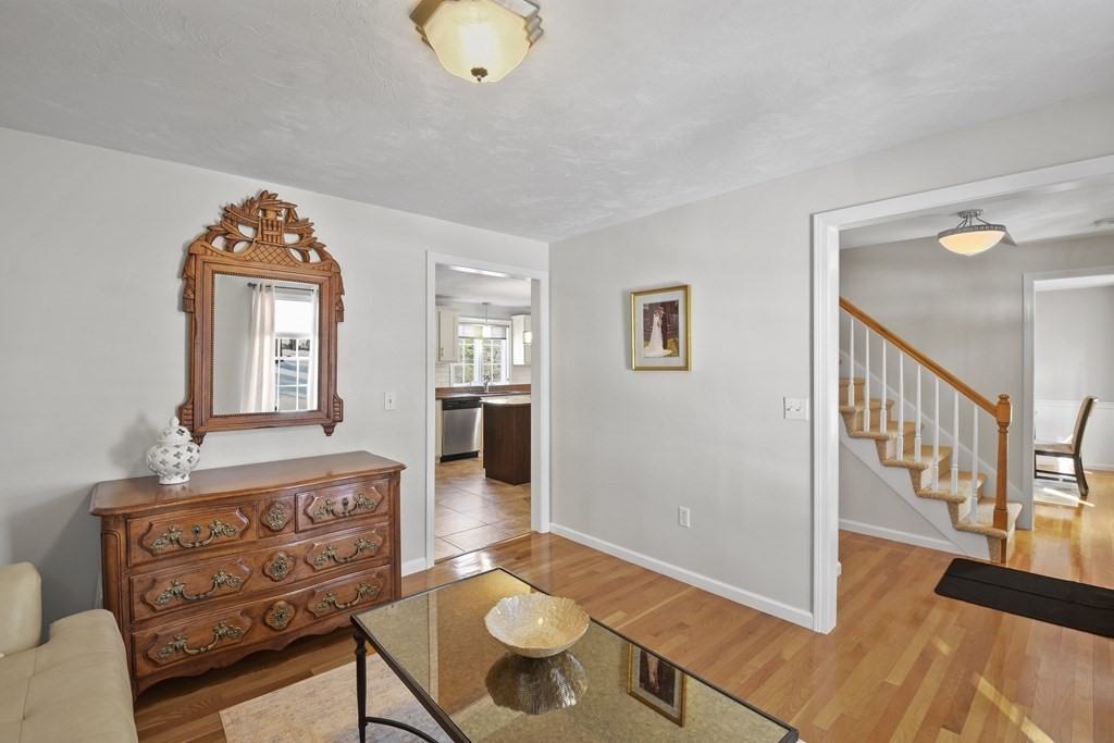 54 Carroll Hill Road Charlton, MA 01507 - Photo 14 of 30 a view of a hallway to a livingroom and dining room with furniture wooden floor a rug and a large window